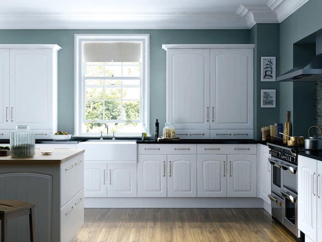 Finished kitchen concept: white cabinets, dark countertops, farmhouse sink under the window, wood-look flooring